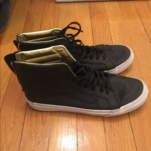 All black leather Vans with gold accent and zipper